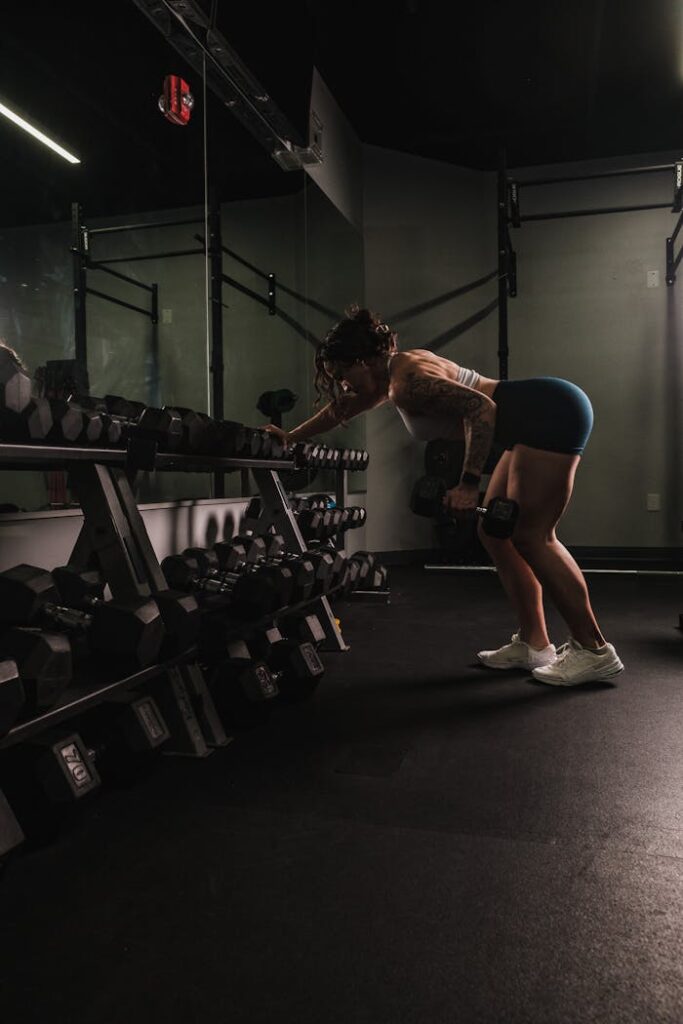 Woman Lifting Weights in a Gym 